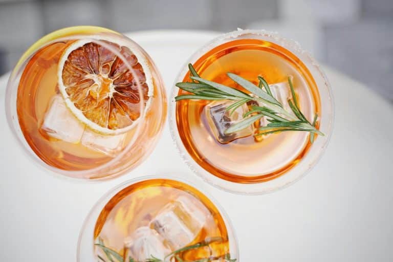 A vibrant assortment of summer mocktails, garnished with fresh fruit and herbs, offering refreshing, alcohol-free drink options for those managing PCOS.