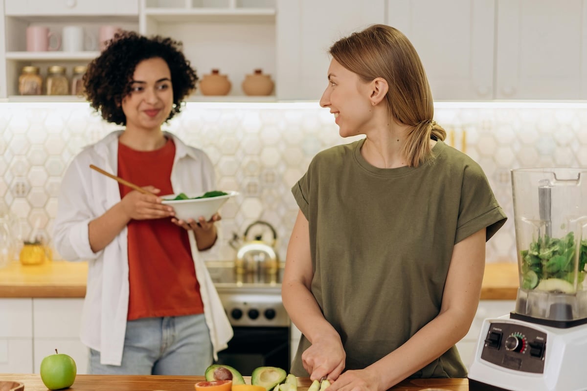 Two woman in a kitchen preparing a PCOS-friendly meal