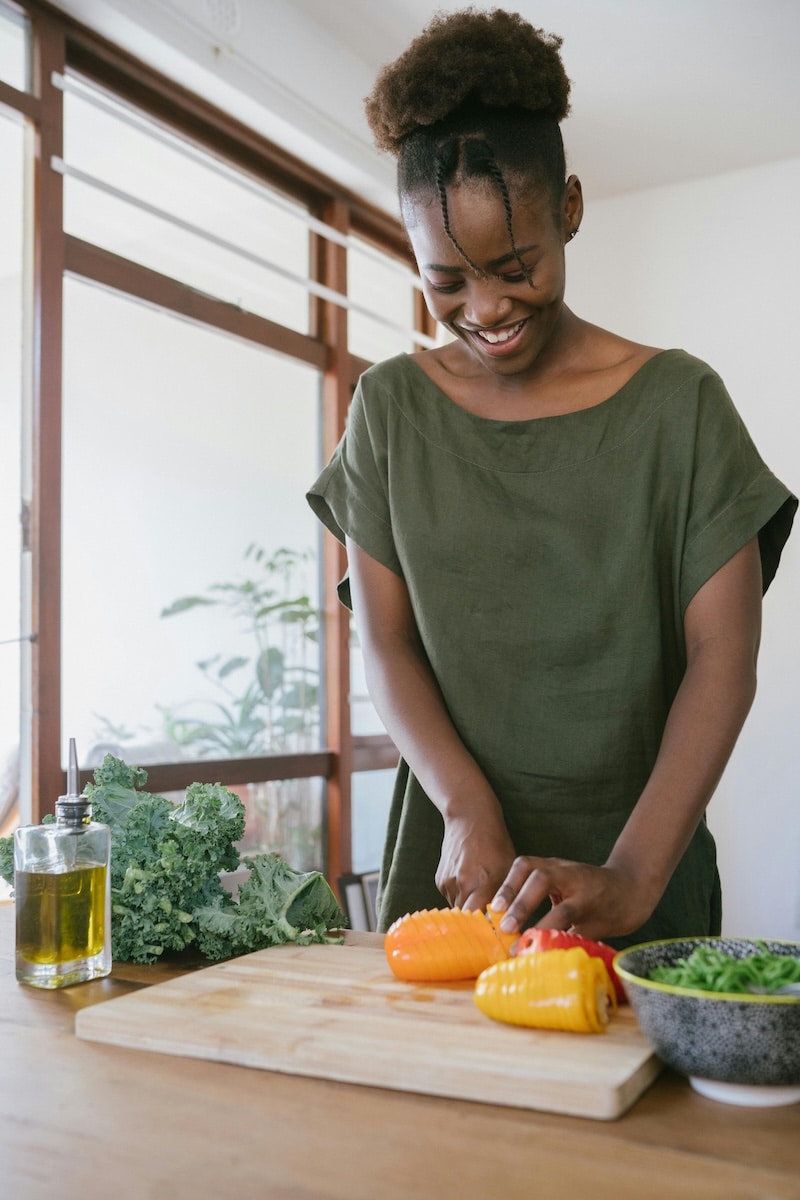 Woman standing at her counter preparing a nutritious, hormone-friendly meal to support PCOS management.