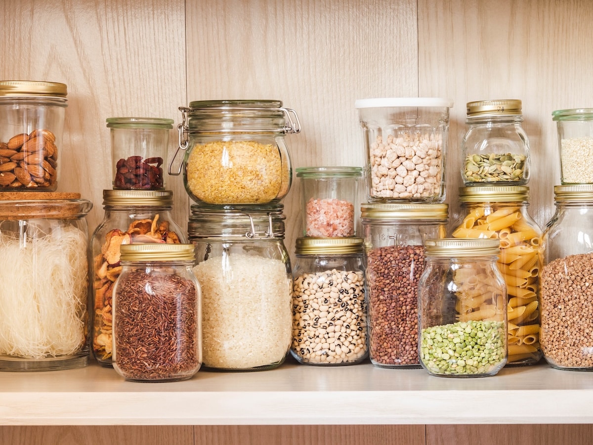 Organized pantry stocked with essentials from a PCOS grocery list, including whole grains, legumes, nuts, seeds, and hormone-friendly snacks.