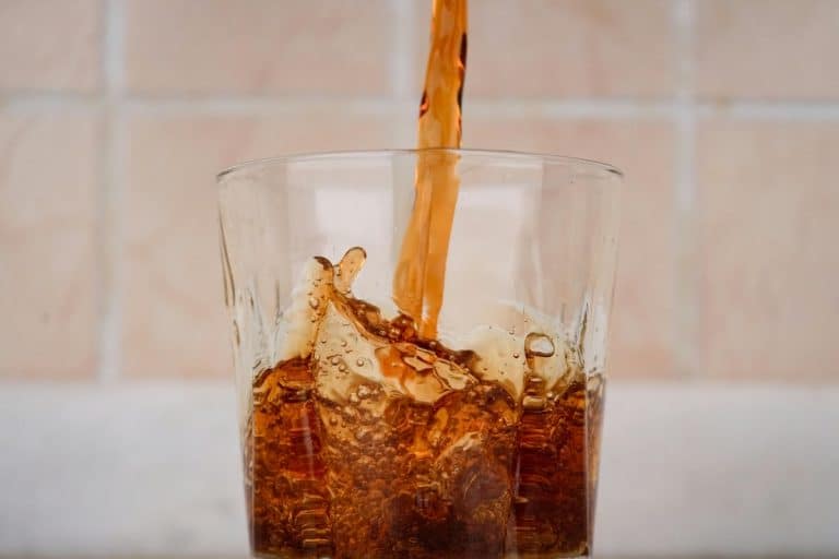 Close-up of diet soda being poured into a glass, illustrating Diet Soda and PCOS discussion.