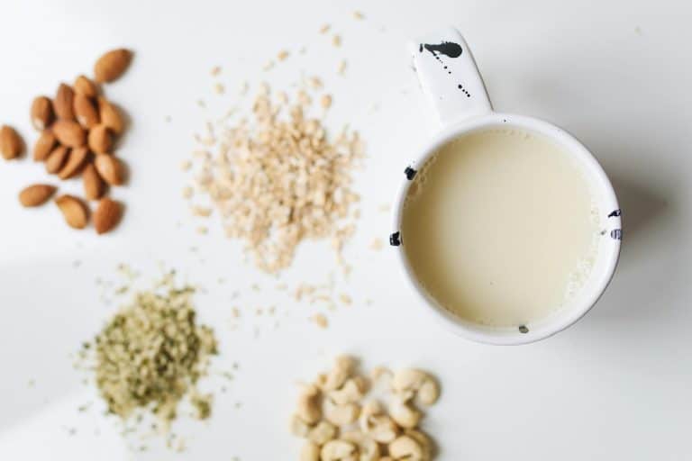 Cup of dairy-free milk with almonds, cashews, hemp seeds, and oats – exploring the best milk for PCOS.