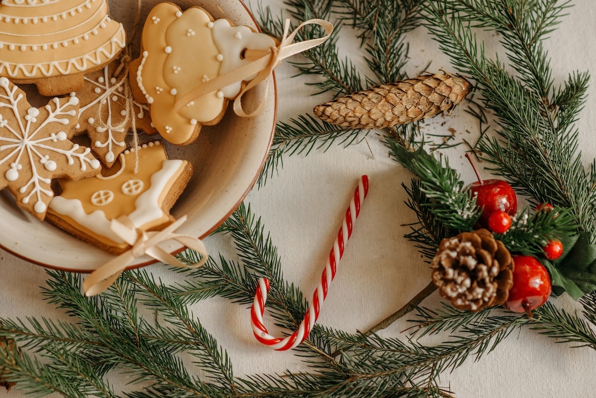 Decorated holiday cookies with pine branches and candy cane, representing mindful dessert choices for a PCOS-friendly holiday season.