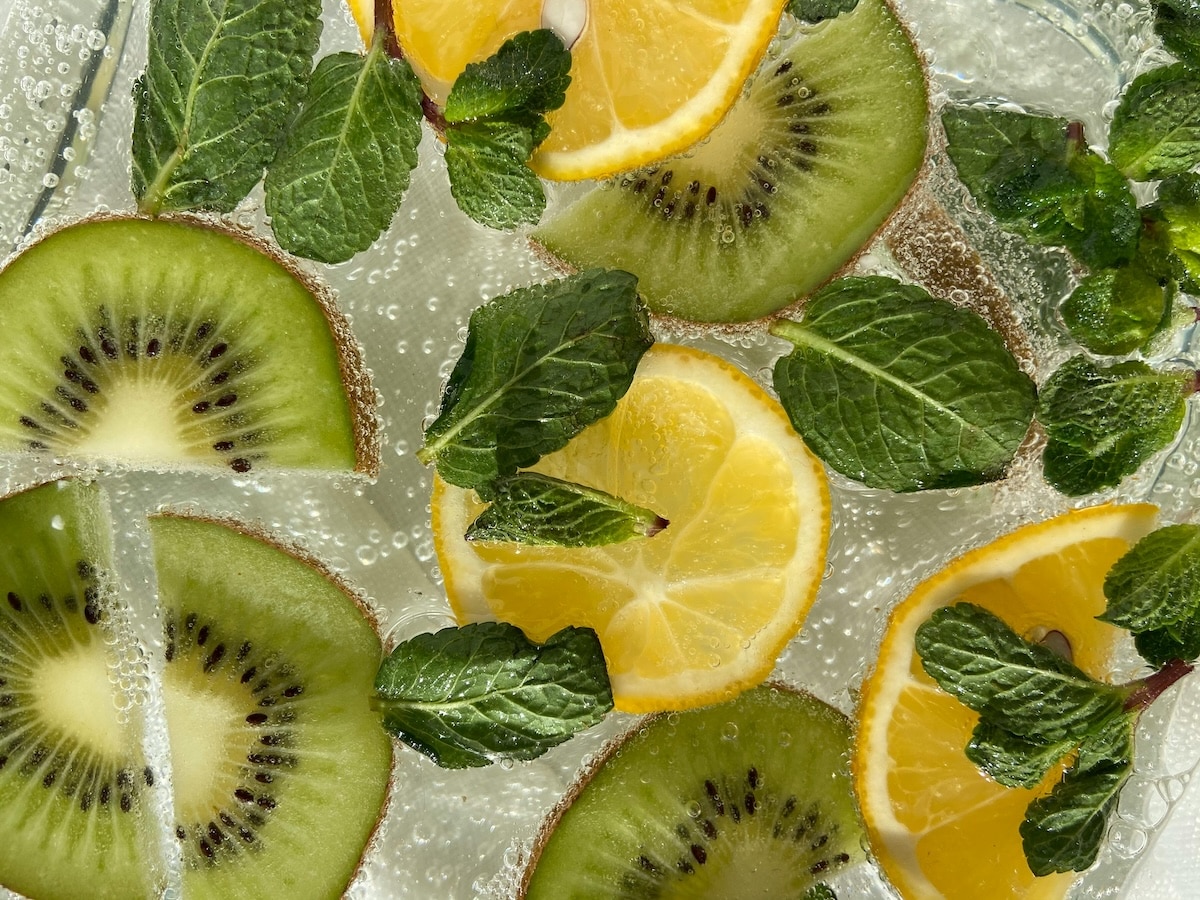 Refreshing water with kiwi, lemon, and mint — hydrating drink that supports digestion and PCOS gut health.