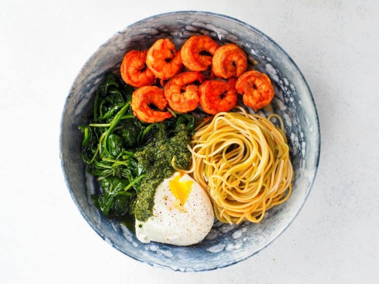 Balanced meal bowl with shrimp, egg, pasta, leafy greens, and healthy fats to support fullness and blood sugar balance after stopping Ozempic.